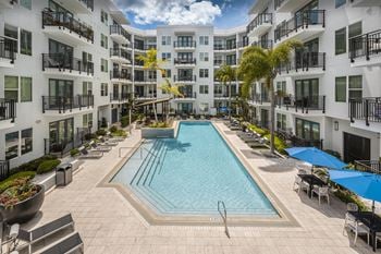Infinity edge swimming pool with cabanas